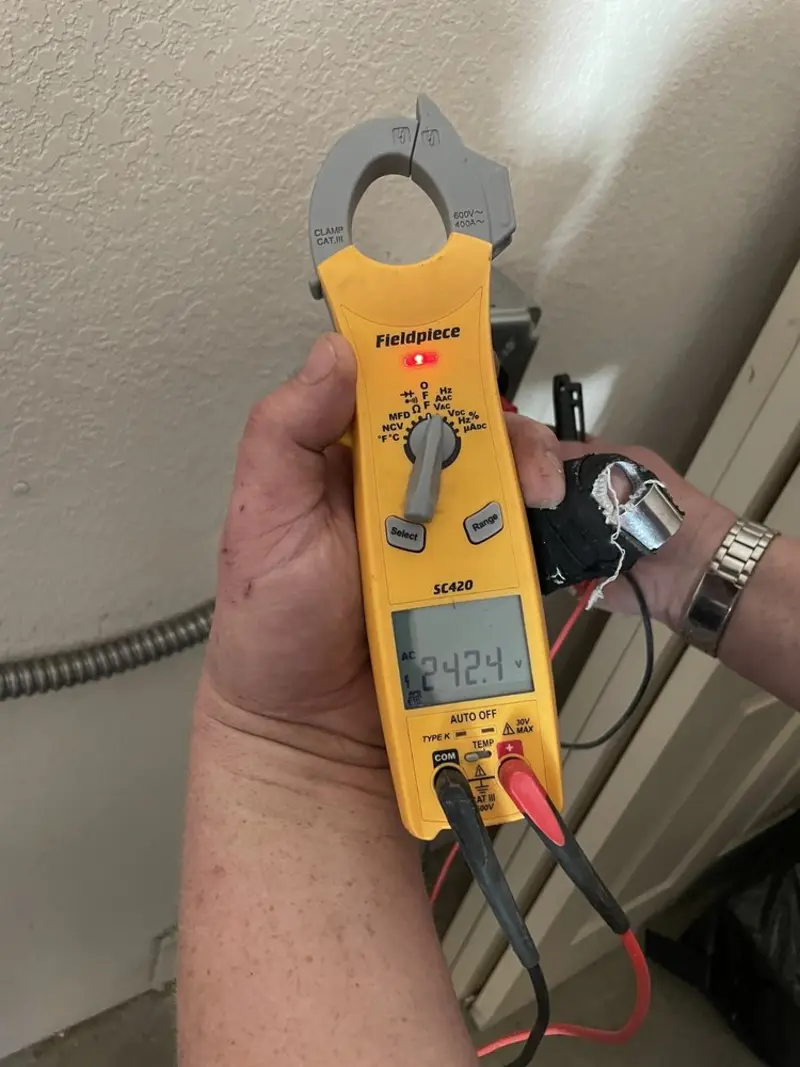 Voltage testing with clamp meter during Electrical Installation Services in Oak Island